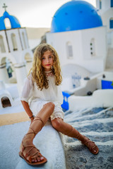 Young and beautiful girl in Oia - Santorini, Greece