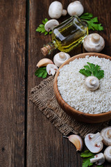 Ingredients for risotto: rice, mushroom, garlic, oil