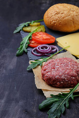 Ingredients for burger: raw cutlet, tomato, cheese, onion