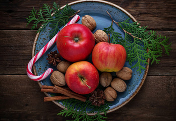 Christmas composition with apples, nuts and cinnamon