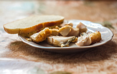 Fototapeta na wymiar Fried fish with bread on a plate