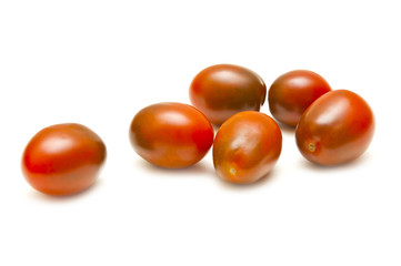 Several red tomatoes on a white background