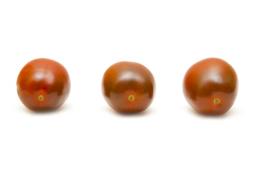 Three red tomatoes on a white background