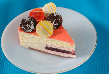 Floating Raspberry White Chocolate Mousse with chocolate coin topping on blue fabric background