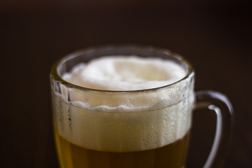 Mug of beer on wooden background