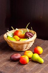 A basket of chocolates from marzipan in the form of fruits is no