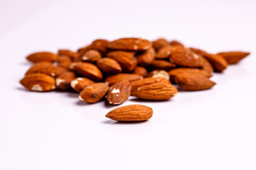 ..One small handful of almonds is on the table.