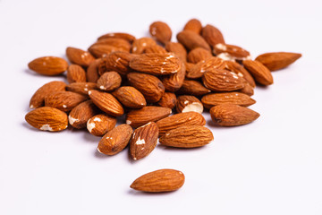 ..One small handful of almonds is on the table.