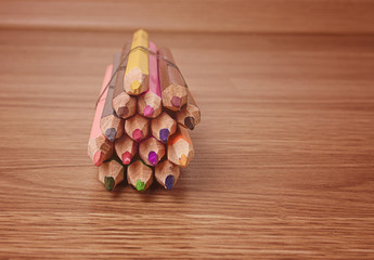 colored pencils on wooden background
