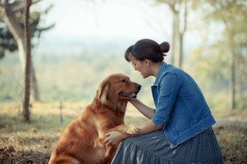 Beautiful woman with a cute golden retriever dog