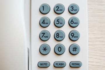 Close up of telephone keypad on the wooden table