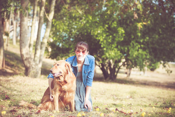 Beautiful woman with a cute golden retriever dog