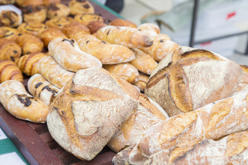 Freshly baked traditional bread ready to meal on wooden table
