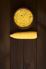 Traditional Chilean corn pie called Pastel de Choclo, photographed on dark wood  with natural light