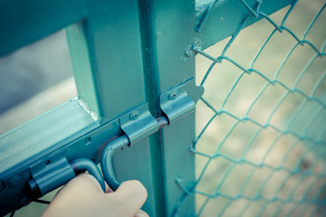 Green metal fence lock with pastel tone