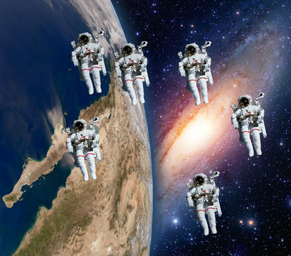 Many astronauts spaceman spacewalk space theme team walk milky way galaxy. Elements of this image furnished by NASA.
