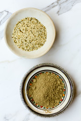 Bowls of protein-rich hemp seeds and powder