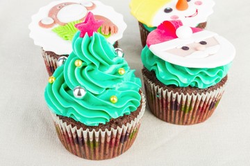 Seasonal festive Christmas mini dessert cupcakes in traditional decorative symbols elements.