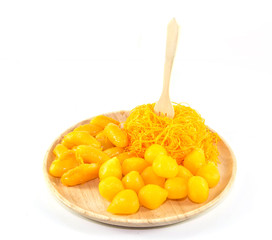 thai sweetmeat dessert made from egg and sugar on wood dish isolate on white background, top view