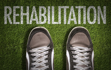 Top View of Sneakers on the grass with the text: Rehabilitation
