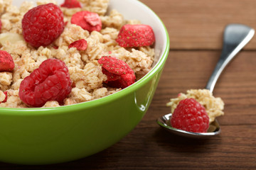 musli with fresh raspberry on wooden background