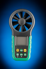 Digital handheld anemometer isolated on blue background
