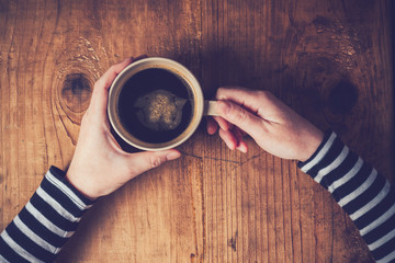 Lonely woman drinking coffee in the morning