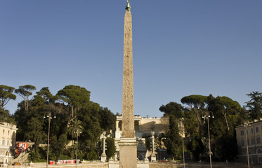 The Egyptian obelisk of Ramesses II in Piazza del Popolo in Rome, Italy, surrounded by trees