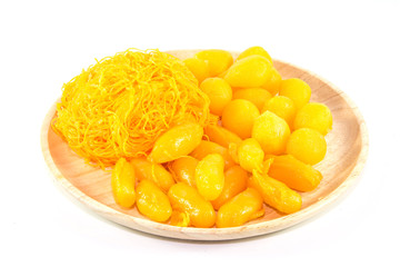 thai sweetmeat dessert made from egg and sugar on wood dish isolate on white background, top view