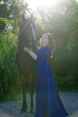 Beautiful young woman with a horse