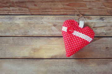 image of colorful fabric heart on wooden table. valentine's day celebration concept
