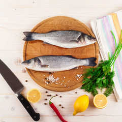 Two fresh sea bass on a white background. Top view.
