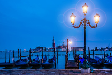 Gondolas in Venice - twilight with San Giorgio Maggiore church. San Marco, Venice, Italy