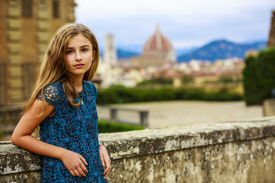 Portrait of young and beautiful girl in Florence, Italy. In background Cathedral Santa Maria del Fiore