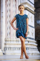 Beautiful young girl in dress posing in Siena, Italy
