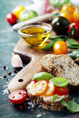 Obraz na płótnie Canvas Tomato and basil sandwiches with ingredients