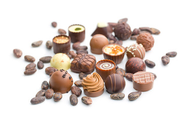 various chocolate pralines and cocoa beans