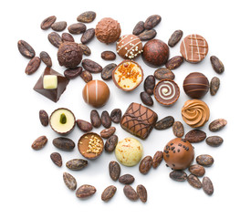 various chocolate pralines and cocoa beans