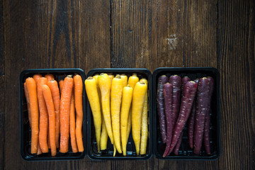 Rainbow carrots on wooden board