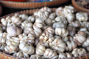 Fresh garlics bulb cloves in the basket stall at market for sell
