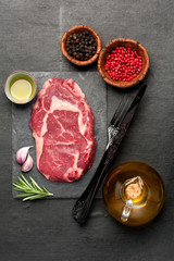 Raw fresh meat Ribeye Steak, seasoning and herbs