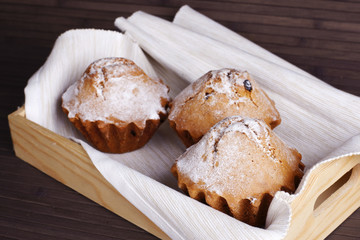 Fototapeta na wymiar Muffin cakes on a white tablecloth.