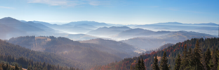 Morning mist in mountains. Sunrise and autumn mist over the hill