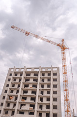 Fototapeta premium Building multistorey houses and hoisting cranes
