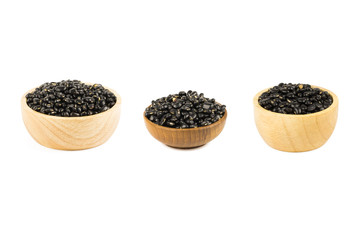Seed black beans in wood cup isolated on white