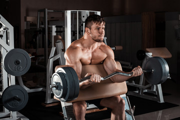 Fototapeta na wymiar Muscular man workout with barbell