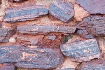 volcanic breed in the earth. natural minerals of volcanic breed with the content of iron ore. stones for design of streets of parks. stone road.background cold stones of a lava.