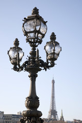 Fototapeta na wymiar Lamppost on Pont Alexandre III Bridge with the Eiffel Tower in the Background in Paris, France