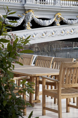 Tables and Chairs on Deck of Boat on the River Seine next to Pont Alexandre III Bridge in Paris, France