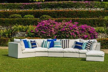 Water resistant outdoor sofa with cushions and pillows in the garden